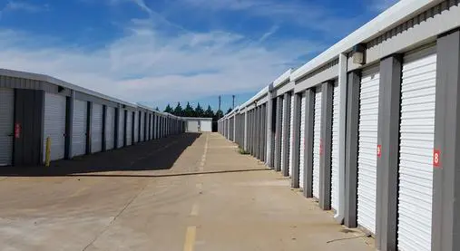 A long row of storage units on the side of a road.