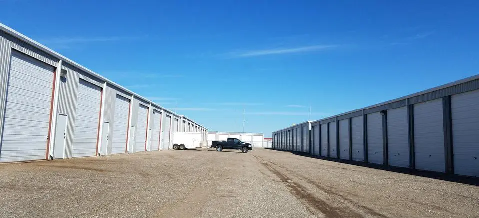 A truck parked in front of several storage units.